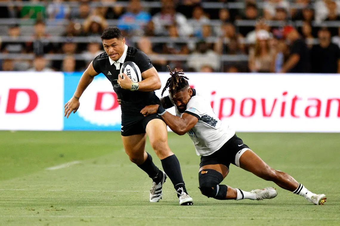 The All Blacks' Caleb Clarke is tackled by Fiji's Waisea Nayacalevu in their  International Test  at Snapdragon Stadium on July 19, 2024 in San Diego, California.