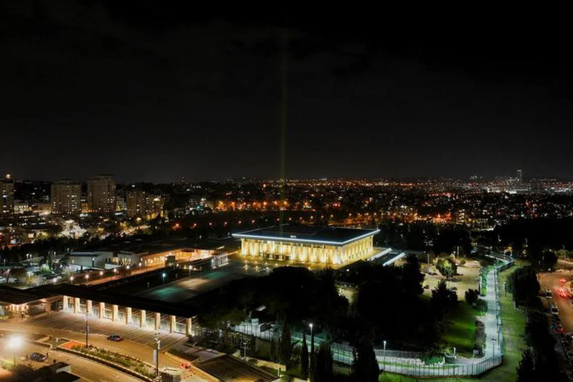 The Knesset, the Israel parliament, is lit in yellow in support of the hostages who are being held in Gaza after they were kidnapped from Israel by Hamas gunmen, as the conflict between Israel and the Palestinian Islamist group Hamas continues, in Jerusalem, December 31, 2023. REUTERS/Ilan Rosenberg/File Photo