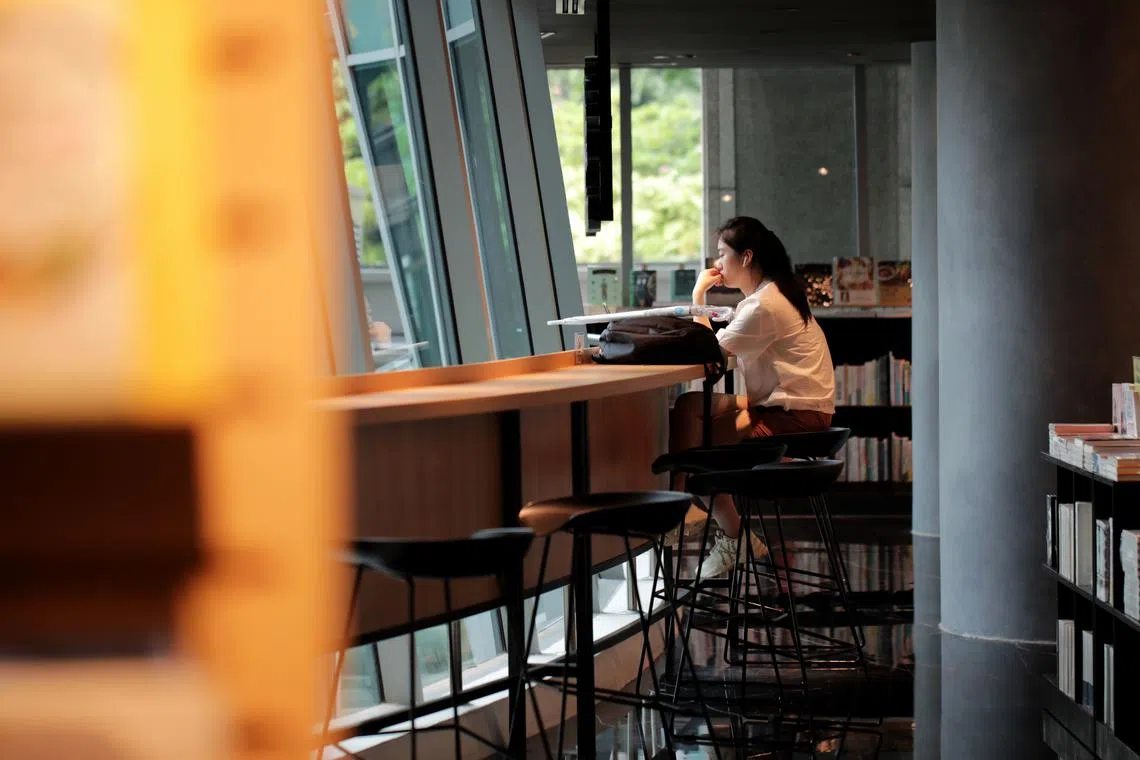 ST20230627_202336239853: Gin Tay /Pixgeneric/ Generic photo of a woman on her laptop at The Zall Bookstore on June 27, 2023. Can use for stories on woman, loneliness, quiet time, self care,