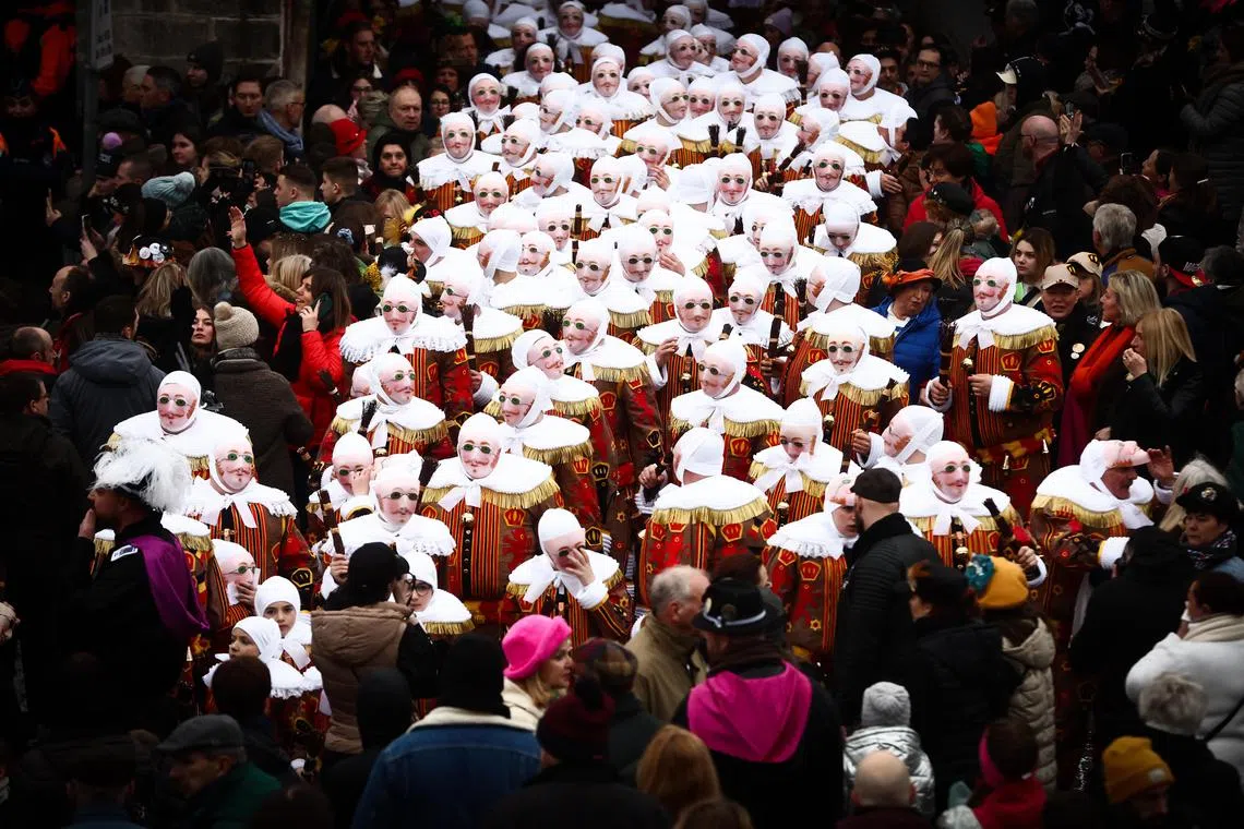 Festival participants known as 'Gilles' wearing traditional costumes during Carnival celebrations in the streets of Binche, Belgium, Feb 21, 2023. The Carnival de Binche is a popular historical cultural event that was named a Masterpiece of the Oral and Intangible Heritage of Humanity by Unesco in 2003. 