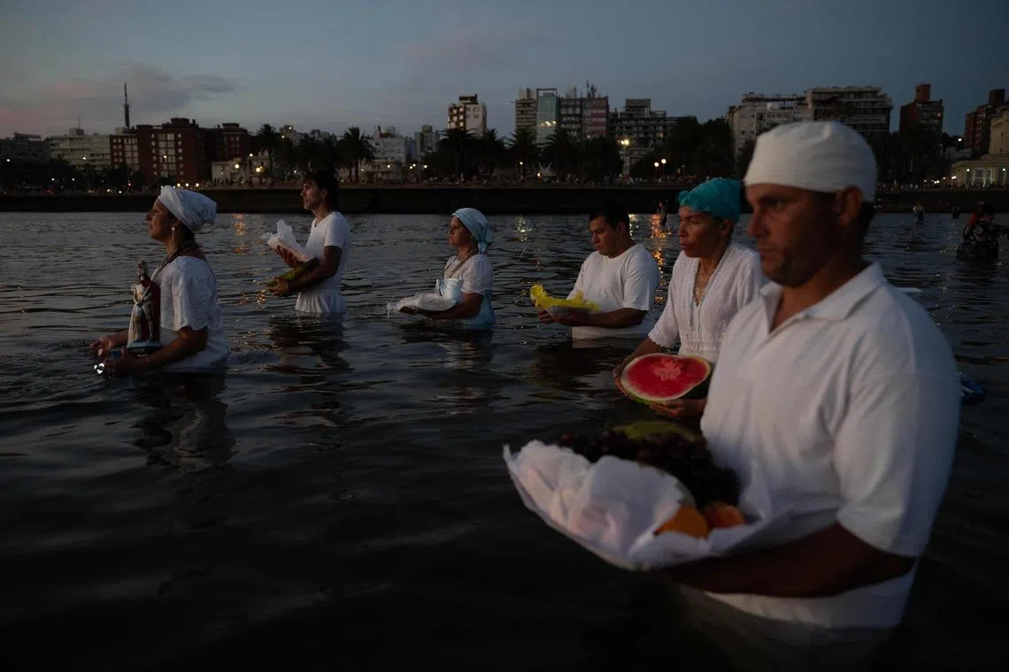 Believers offering tribute to Iemanja, the Goddess of the Sea of the Afro-American religion Umbanda, at Ramirez Beach in Montevideo, Uruguay on Feb 2, 2026. 