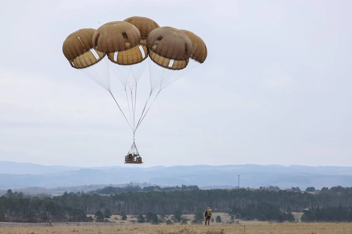 Military equipment was parachuted from a A400M aircraft during a large-scale military drill called "Orion" in Castres, southwestern France, on Feb 25, 2023. 