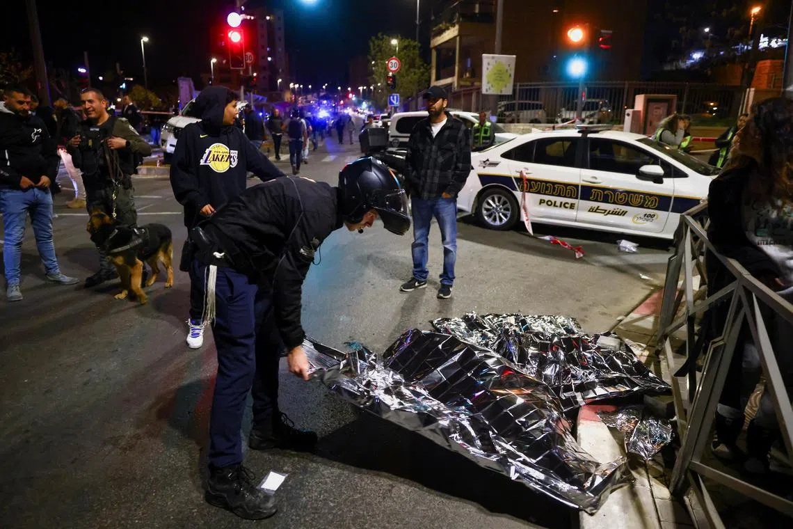 Israeli forces work at the scene of a shooting attack, on Jan 27, 2023.