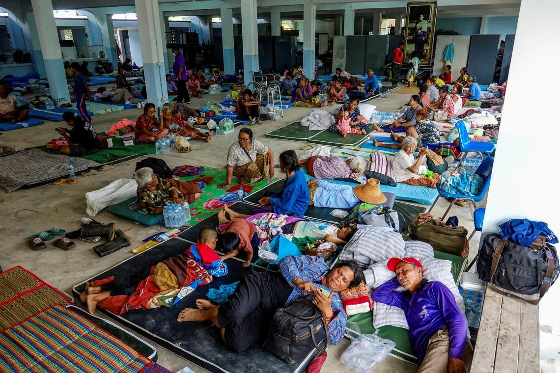 People rest at a shelter, following recent clashes along the disputed border between the two countries, according to authorities people have been killed across three border provinces, in Surin province, Thailand, July 24, 2025. REUTERS/Pansira Kaewplung TPX IMAGES OF THE DAY
