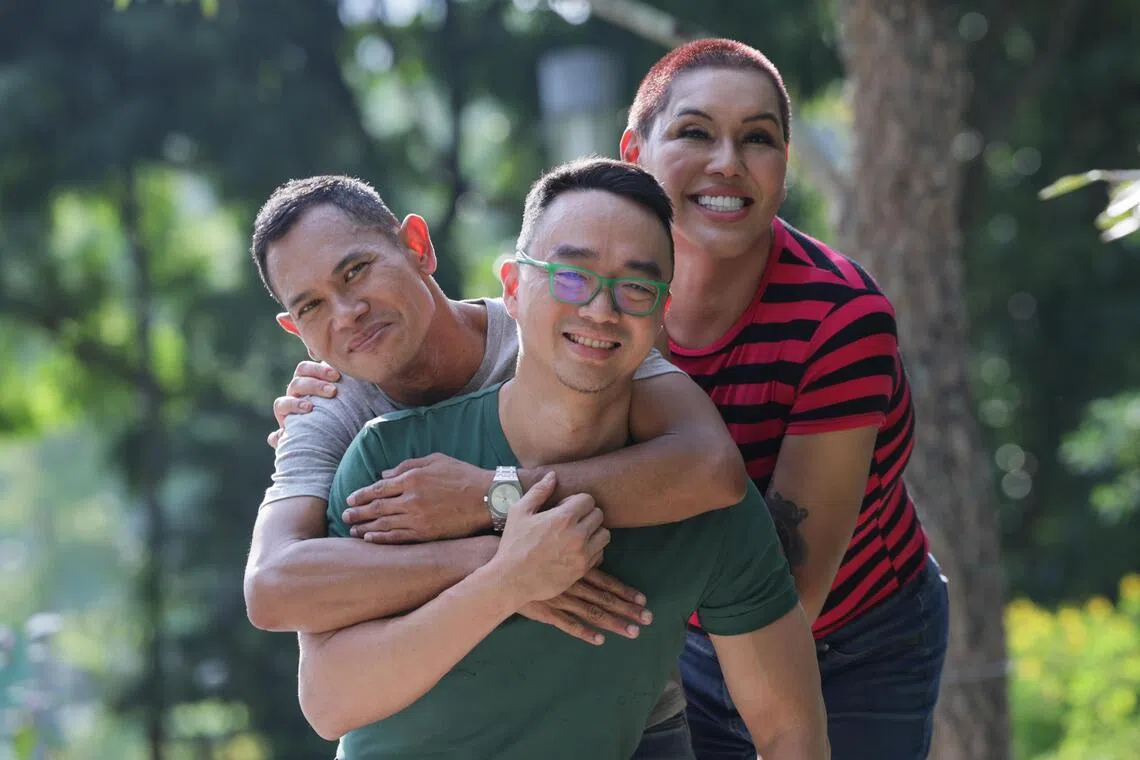 Writer and editor Jason Wee (centre), with book subjects Daniel Askre (left), and Shania Saudah, published the first book in Singapore that features LGBTQ families coming out with their stories.