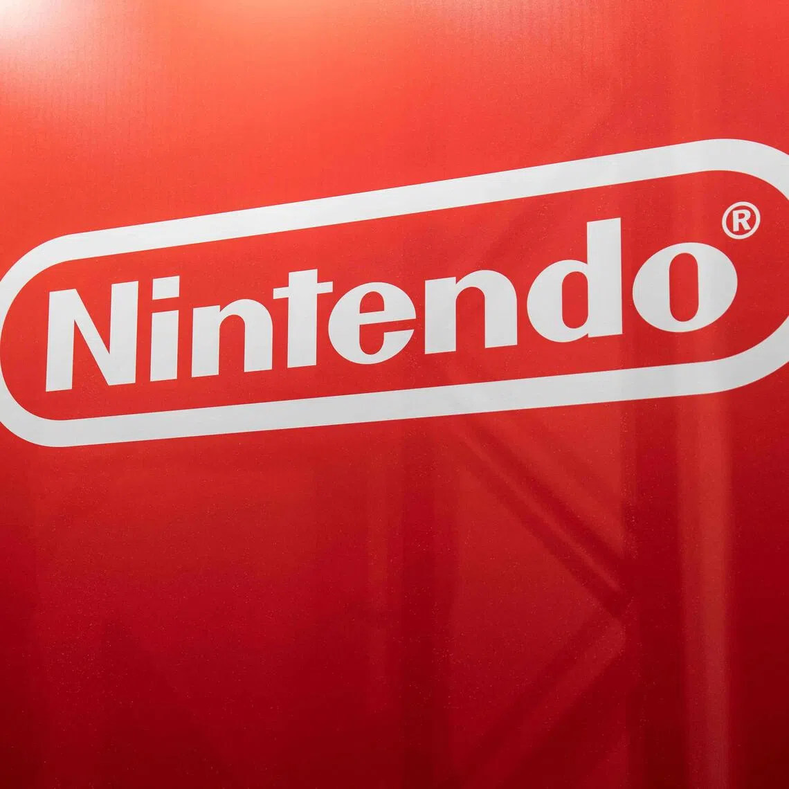 A visitor walks past a Nintendo sign during the BitSummit indie gaming expo in Kyoto city, Kyoto prefecture on July 18, 2025. 