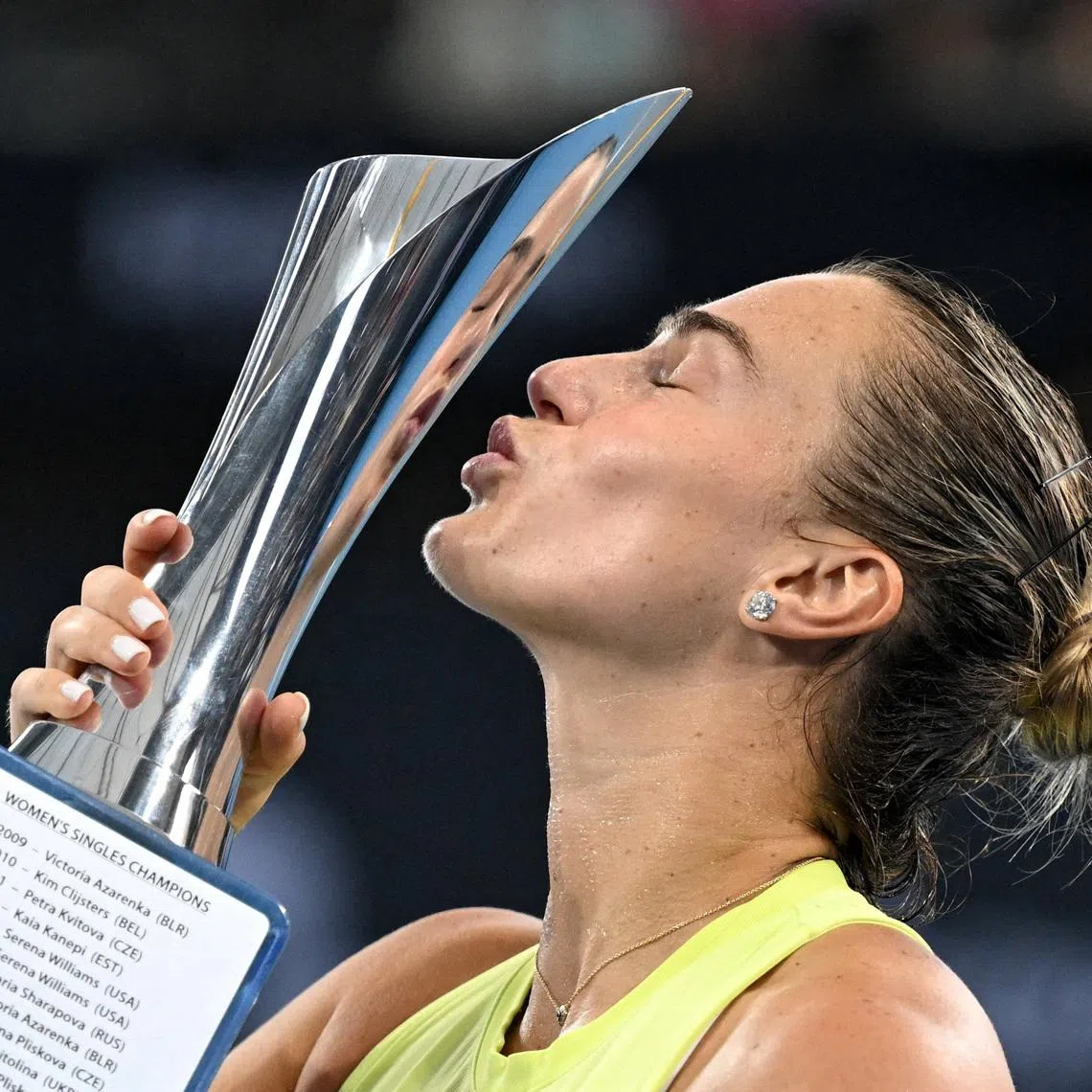 Tennis - Brisbane International Tennis Tournament - Pat Rafter Arena, Brisbane, Australia - January 11, 2026 Belarus' Aryna Sabalenka celebrates with the trophy after winning the final against Ukraine's Marta Kostyuk REUTERS/Dan Peled
