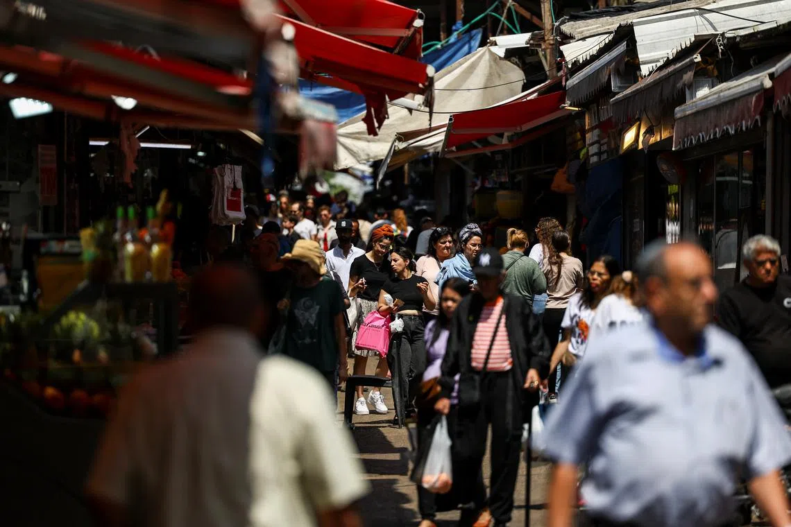 People walk, after Iran launched drones and missiles towards Israel, in Tel Aviv, Israel, April 14, 2024. REUTERS/Hannah McKay