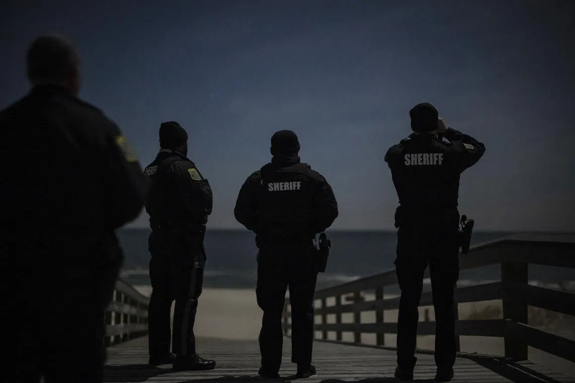 Ocean County Sheriff officers scan the night sky for drones at Island Beach State Park on Dec 13.