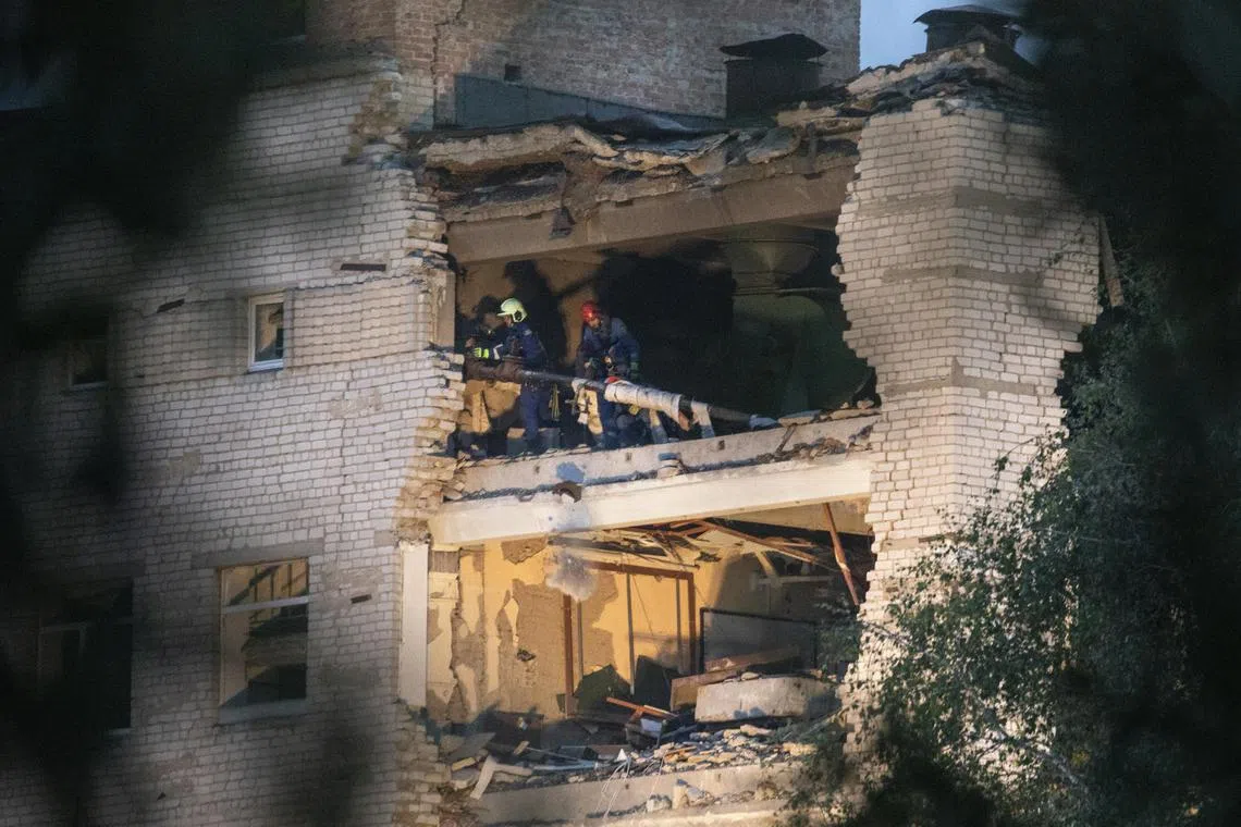 Rescue workers clearing debris from a military academy struck by Russian missiles in Poltava, Ukraine, on Sept 3.