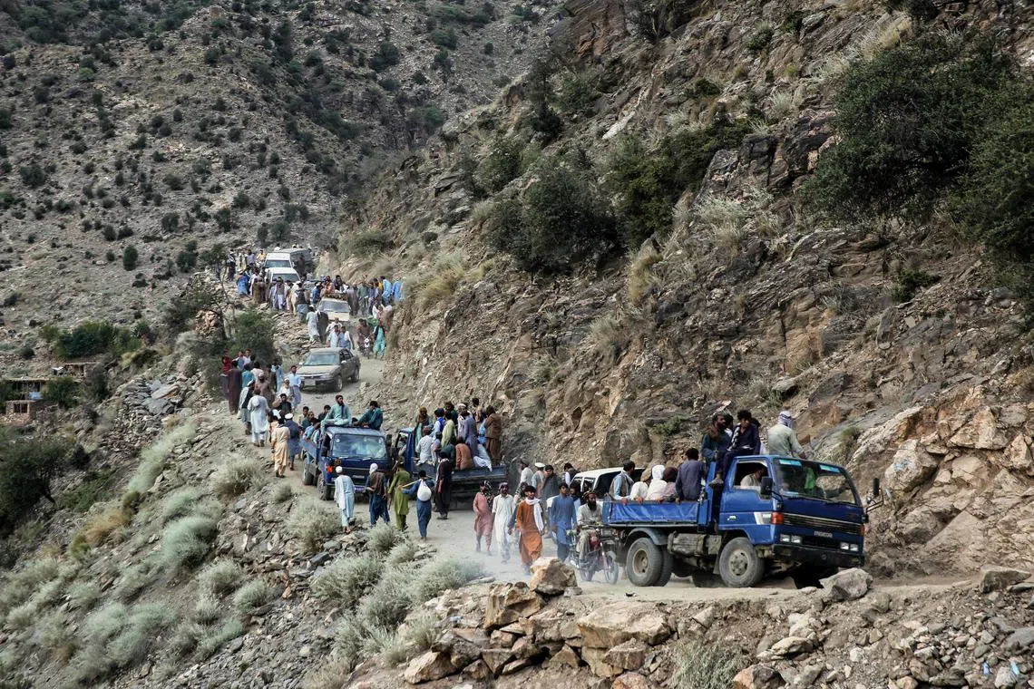 Afghans walking along a hillside, in the aftermath of an earthquake at the Nurgal district of Kunar province, Afghanistan on Sept 3, 2025. Hope was quickly fading of finding survivors in the rubble of homes devastated by the weekend's powerful 6.0-magnitude quake.