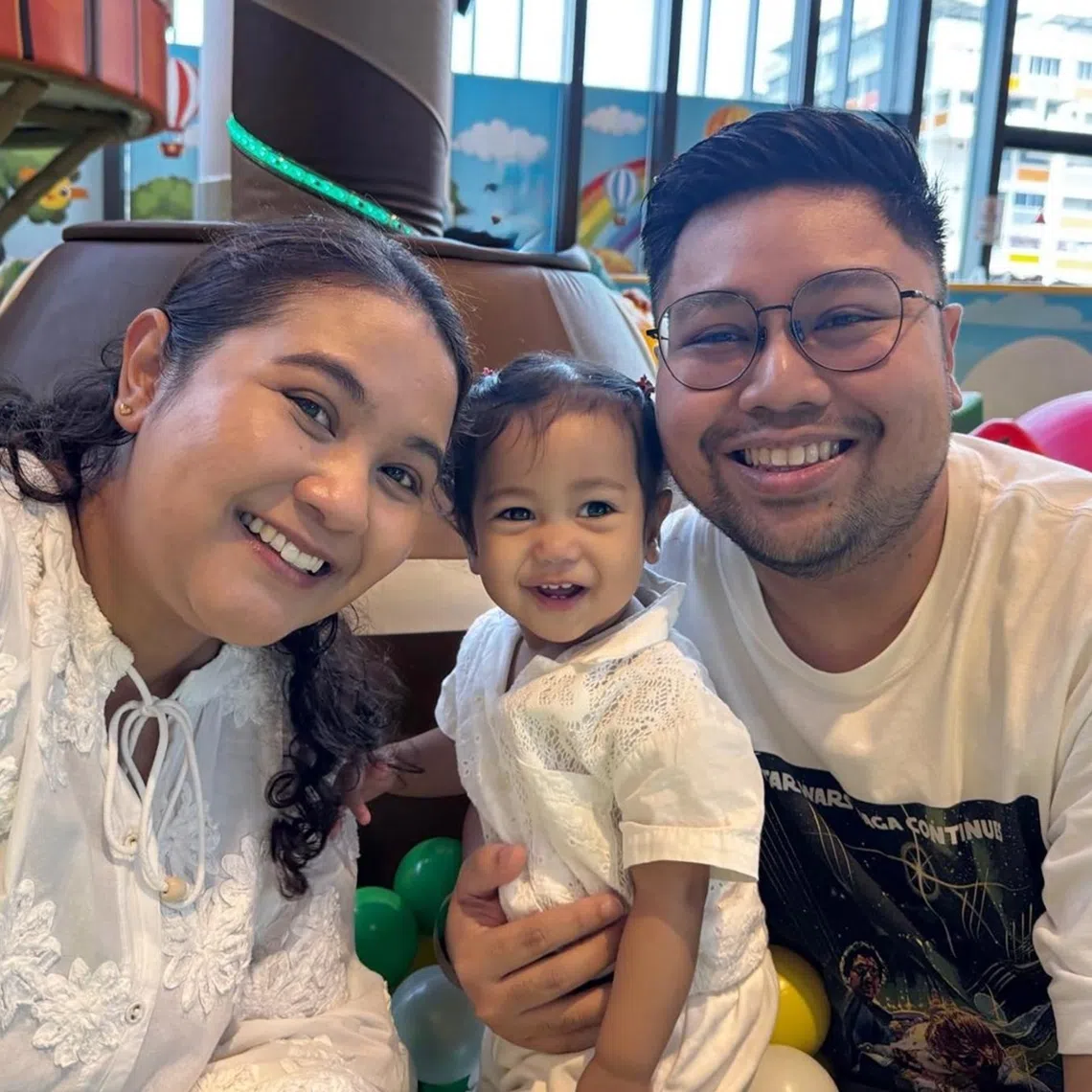 Community manager Shahrin Iskandar (right) with his wife and daughter. The family welcomed the news of upcoming fee reductions for government-supported pre-schools.