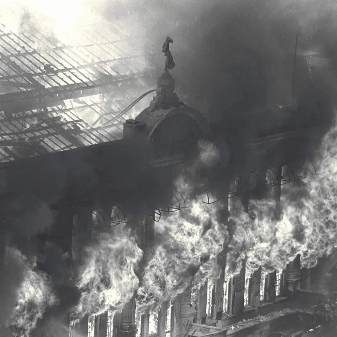 Fire spewing fiercely from the upper windows of Robinson's department store at the height of the blaze at Raffles Place, on November 21, 1972.