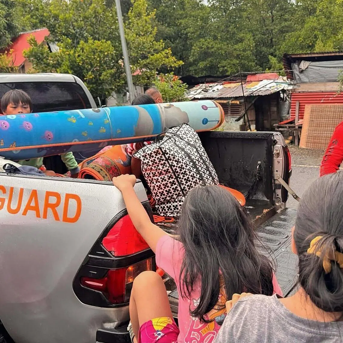 Coast guard personnel assist in evacuating residents along coastal areas of San Julian in central Philippines on Nov 3.