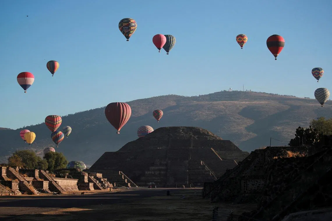 The Pyramid of the Moon was seen on the day of the spring equinox as hot air balloons float above the pre-hispanic city of Teotihuacan, on the outskirts of Mexico City, Mexico, March 20, 2023. 