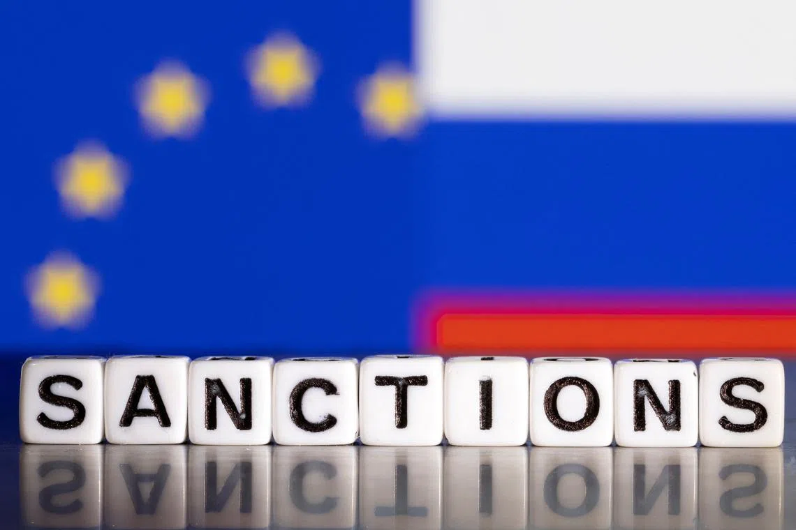 FILE PHOTO: Plastic letters arranged to read \"Sanctions\" are placed in front the flag colors of EU and Russia in this illustration taken February 28, 2022. REUTERS/Dado Ruvic/Illustration/File Photo