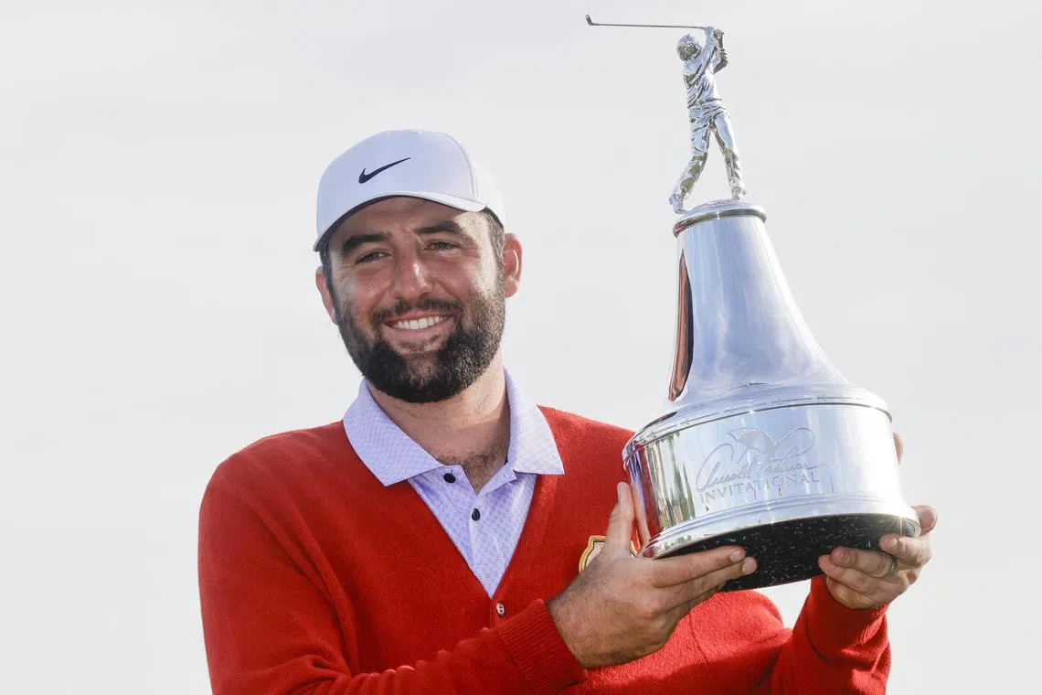 Scottie Scheffler holding the champions trophy after winning the Arnold Palmer Invitational golf tournament. 