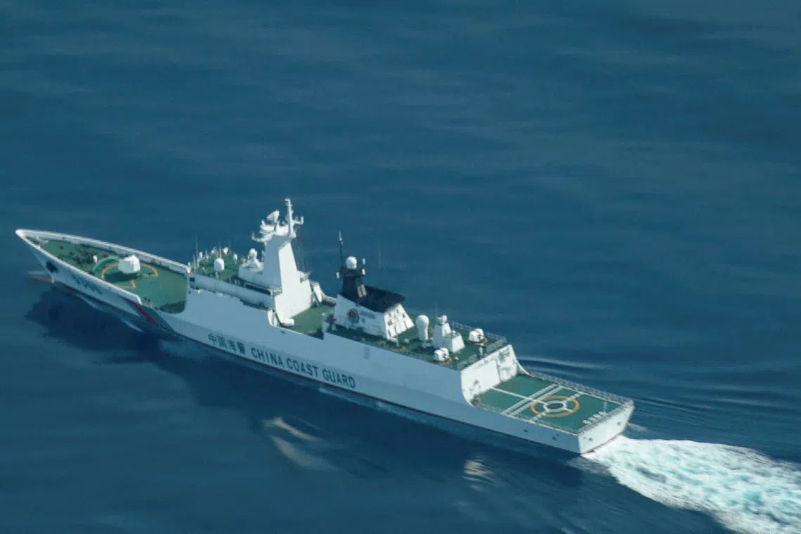FILE PHOTO: An aerial view of a China Coast Guard ship navigating near the disputed Scarborough Shoal, as Philippine Coast Guard aircraft carrying journalists patrols the area, days after two Chinese vessels collided in the area while allegedly trying to block a Philippine supply mission, in the South China Sea, August 13, 2025. REUTERS/Adrian Portugal/File Photo