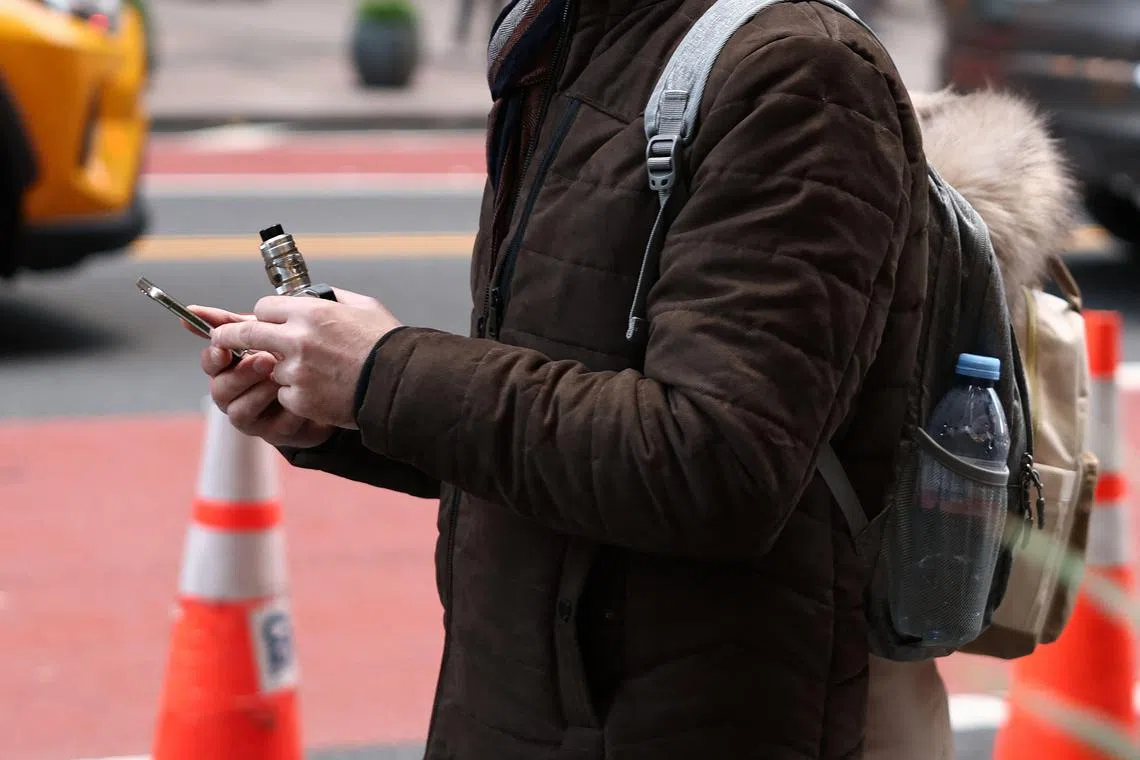 NEW YORK, NEW YORK - DECEMBER 02: A person holds a vape pen as they walk on 42nd Street on December 02, 2024 in New York City. The Supreme Court began to hear arguments on the Food and Drug Administration refusal to approve flavored e-cigarettes over public health concerns.   Michael M. Santiago/Getty Images/AFP (Photo by Michael M. Santiago / GETTY IMAGES NORTH AMERICA / Getty Images via AFP)