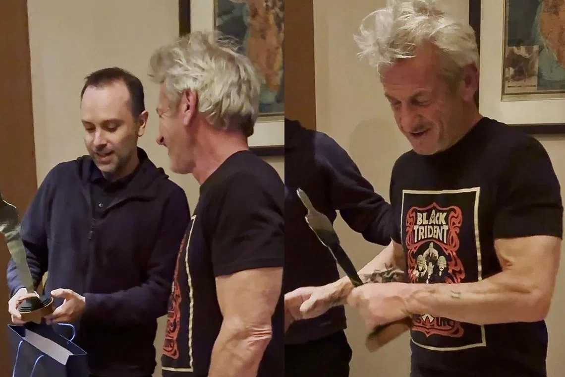 US actor Sean Penn is presented with a silver statue in the shape of an Oscar during his visit to Ukraine.