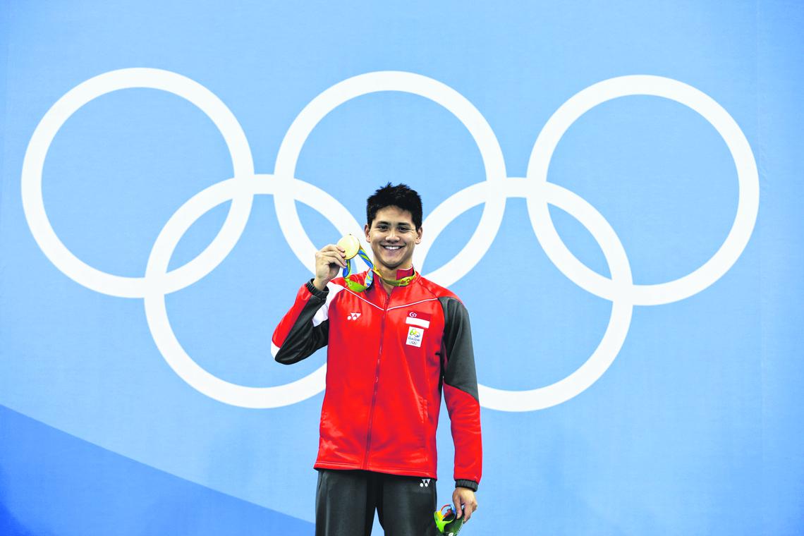 Joseph Schooling of Singapore with the gold medal on the podium after winning the Rio 2016 Olympic Games men's 100m butterfly final at the Olympic Aquatics Stadium in Rio de Janeiro, Brazil, on 12 August 2016.