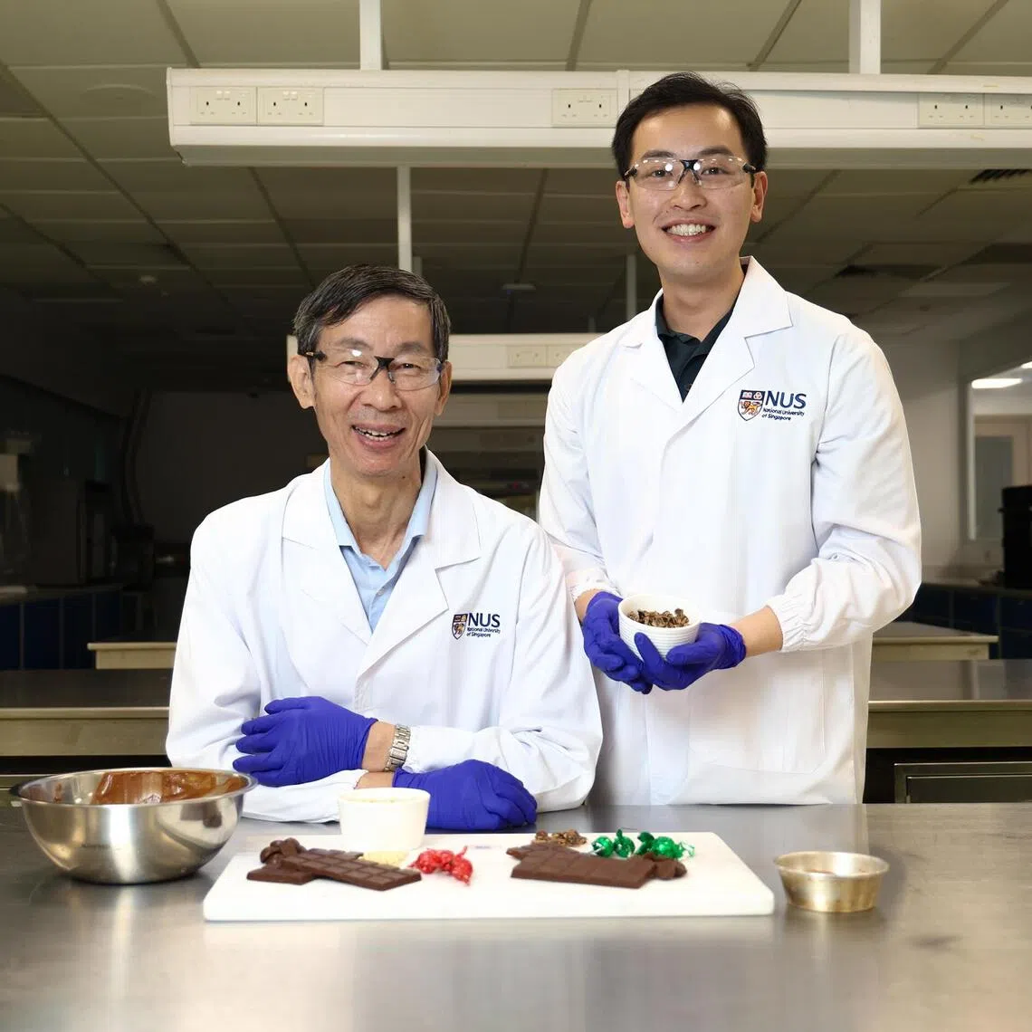 ST20251125_202536000629/ Hester Tan/ hscarob/ NUS created a sustainable alternative to chocolate, carob pulp by grinding and roasting creating 2 versions. Associate Prof Liu Shao Quan (left) and Mr Manfred Ku, PhD student from Department of Food Science and Technology, NUS at 2 Science Drive 2 on 25 November 2025 