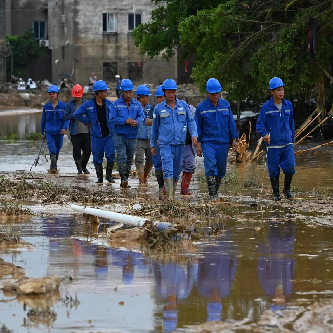 Rescuers scoured flooded areas for survivors after torrential rains wreaked havoc on southern and central China.