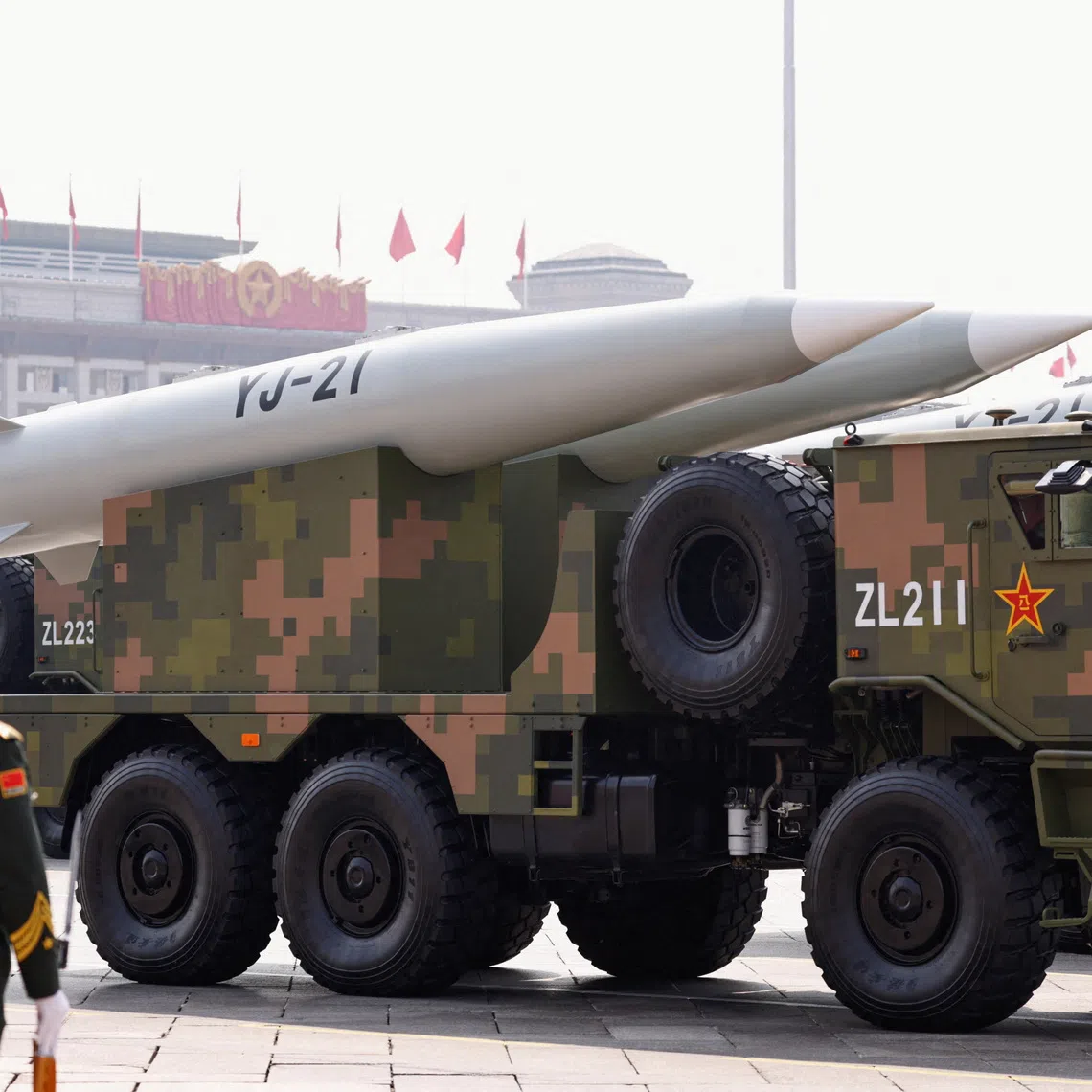 FILE PHOTO: A member of the People's Liberation Army stands as the strategic strike group displays YJ-21 missiles during a military parade to mark the 80th anniversary of the end of World War Two, in Beijing, China, September 3, 2025. REUTERS/Tingshu Wang/File Photo