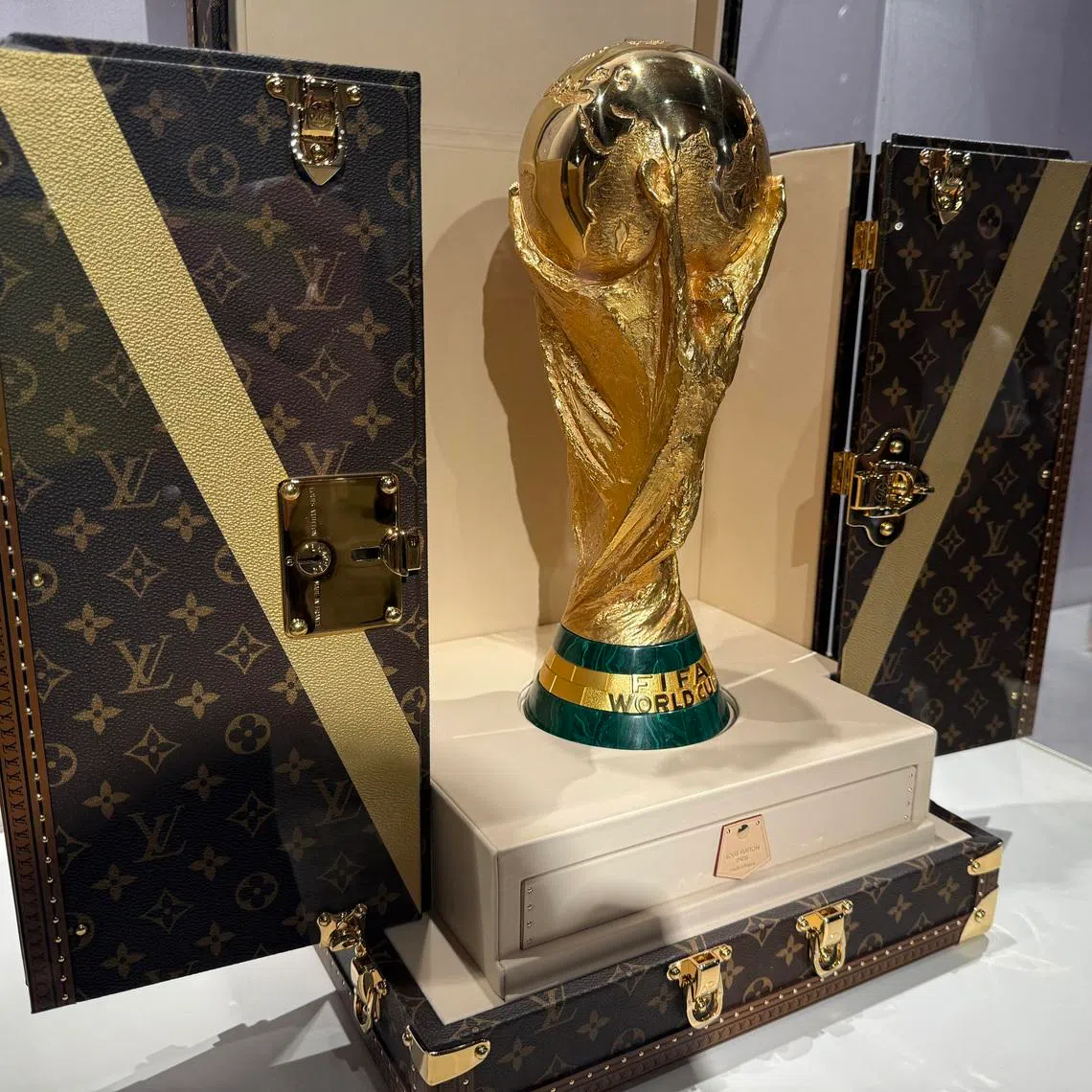 A World Cup replica trophy is displayed in a Louis Vuitton trophy trunk in a store in New York City.