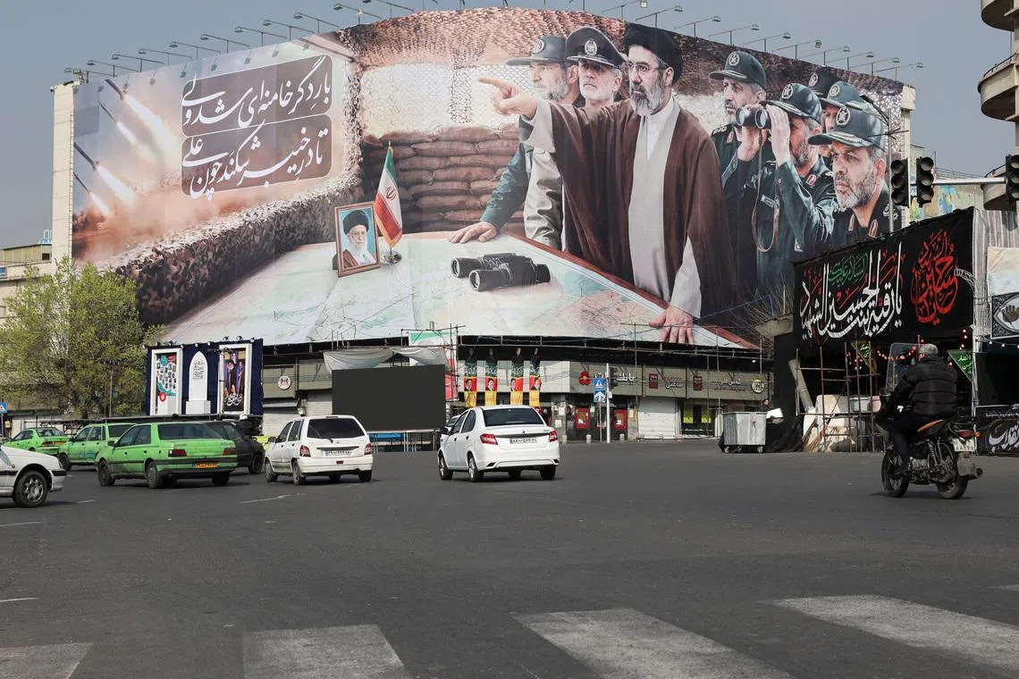 Cars pass a banner featuring Iran's new Supreme Leader Mojtaba Khamenei, amid the U.S.-Israeli conflict with Iran, in Tehran, Iran, March 14, 2026. Majid Asgaripour/WANA (West Asia News Agency) via REUTERS
