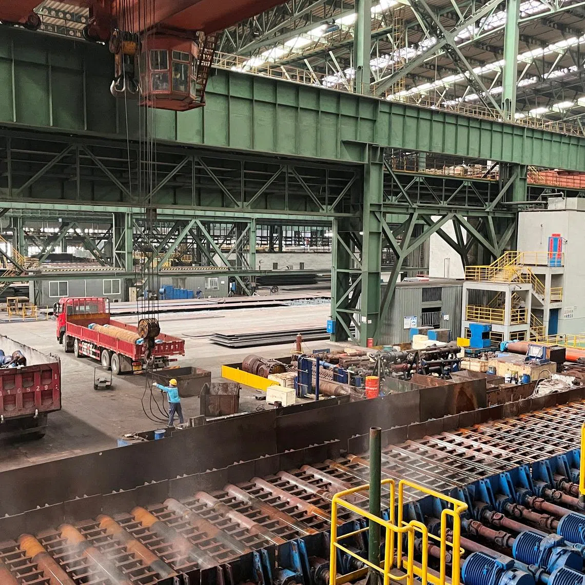 Employees work on the production line at a Baowu Group steel mill in Ezhou, Hubei province, China June 21, 2023.