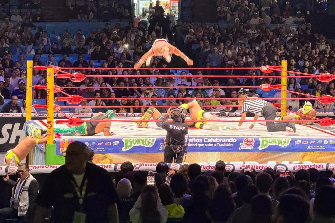 A wrestler flies through the air during a lucha libre show at Arena Mexico on June 9.