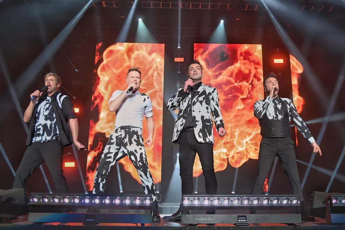 (From left) Kian Egan, Nicky Byrne, Mark Feehily and Shane Filan of Westlife performing at the Singapore Indoor Stadium in February 2023.