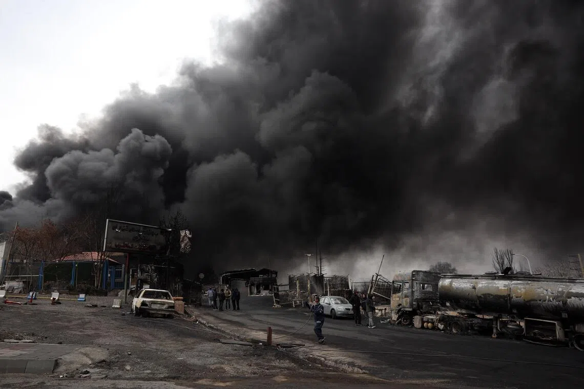 A view of the main gate to the Shahran Oil Refinery as smoke still rises following last night airstrike in Tehran, Iran, on March 8.