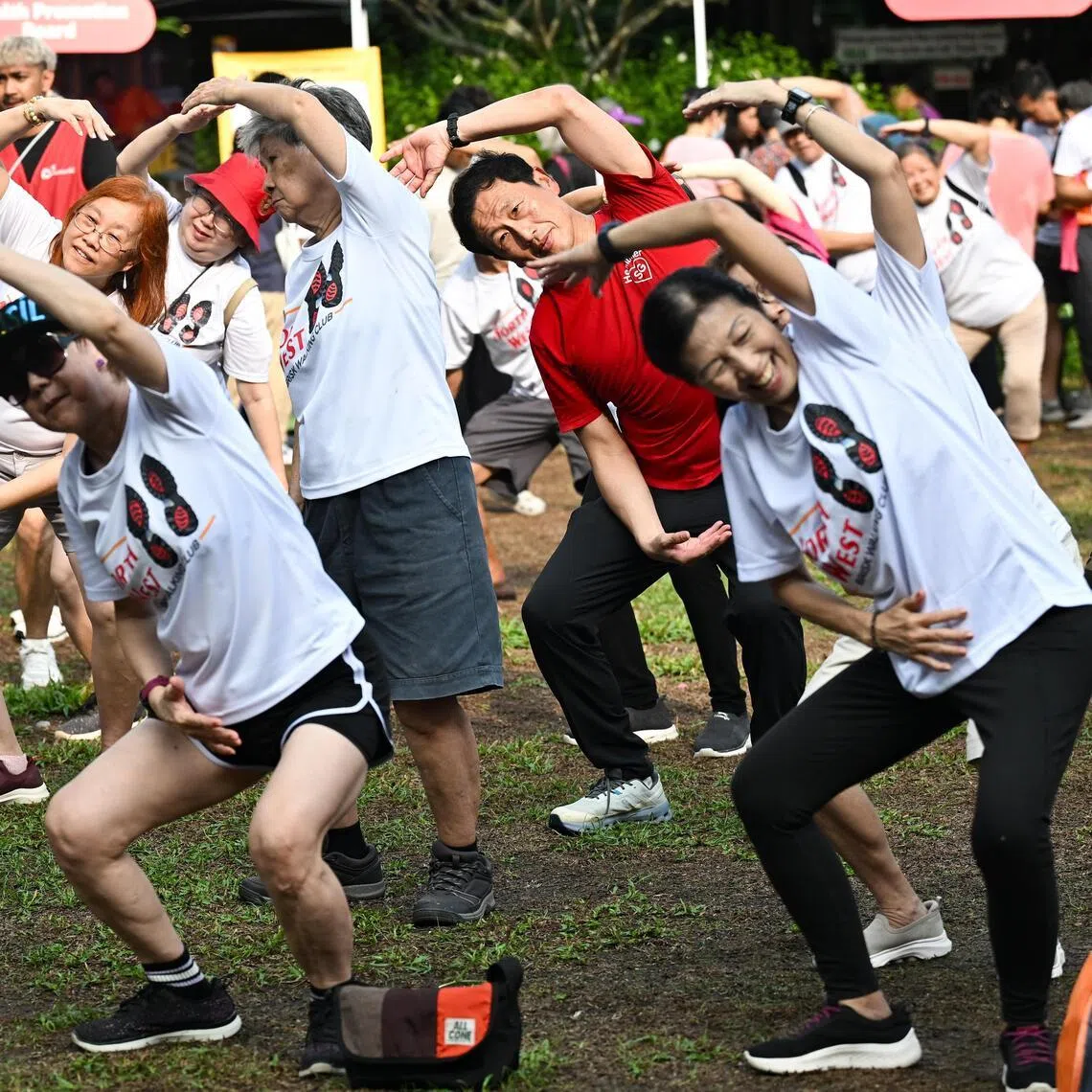 Health Minister Ong Ye Kung taking part in a mass cool-down exercise at a new brisk walking movement in Sembawang Central on April 12. 