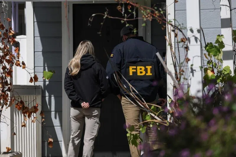 FBI agents leaving the residence associated with Cole Tomas Allen, the suspect in the White House Correspondents' dinner attack, in Torrance, California.