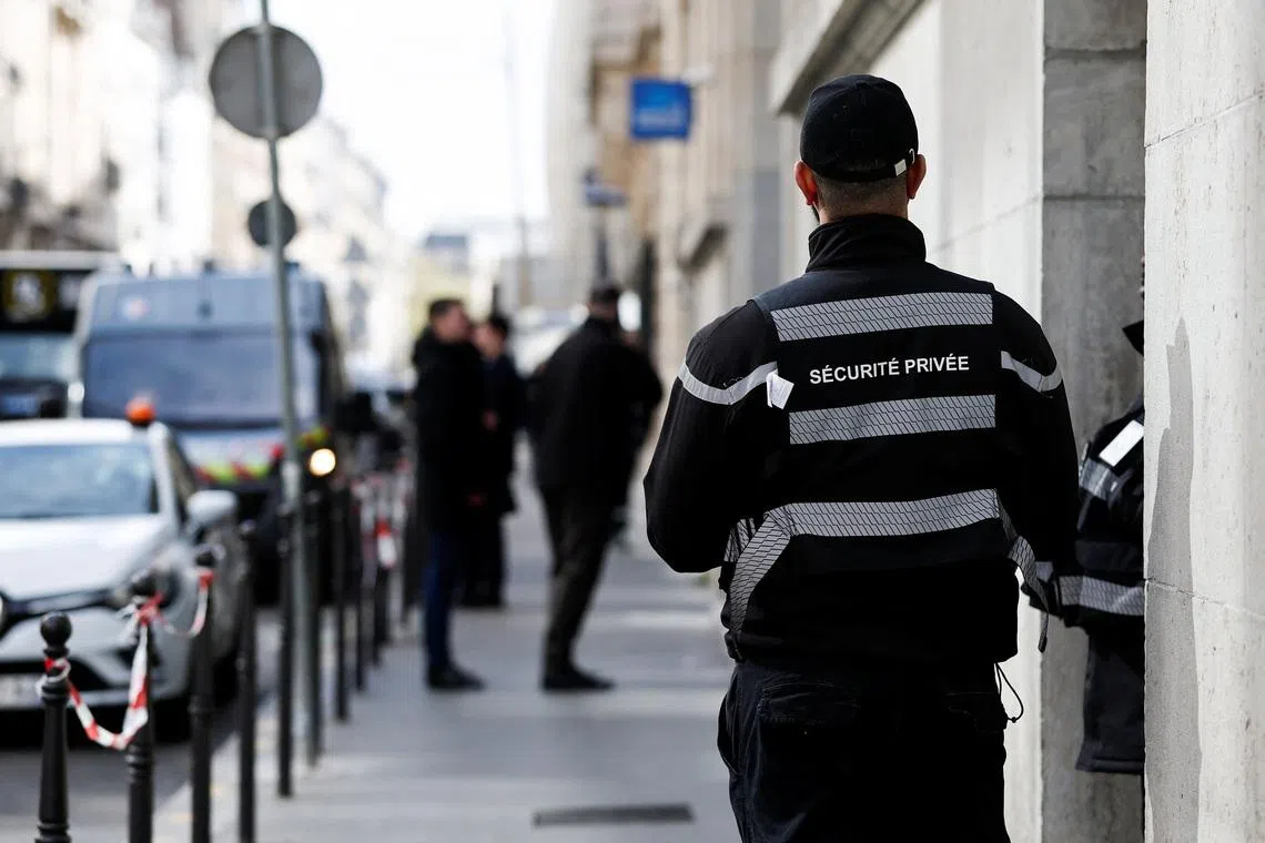 A private security member stands outside Bank of America’s Paris offices, after French anti-terrorism prosecutors opened an investigation into attempted destruction by fire or other dangerous means in Paris, France, March 30, 2026. REUTERS/Benoit Tessier