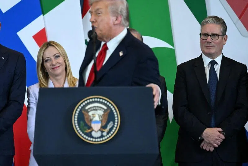 US President Donald Trump (centre) speaks as Italian Prime Minister Giorgia Meloni (left) and Britain's Prime Minister Keir Starmer look on during the Sharm El-Sheikh Peace Summit.