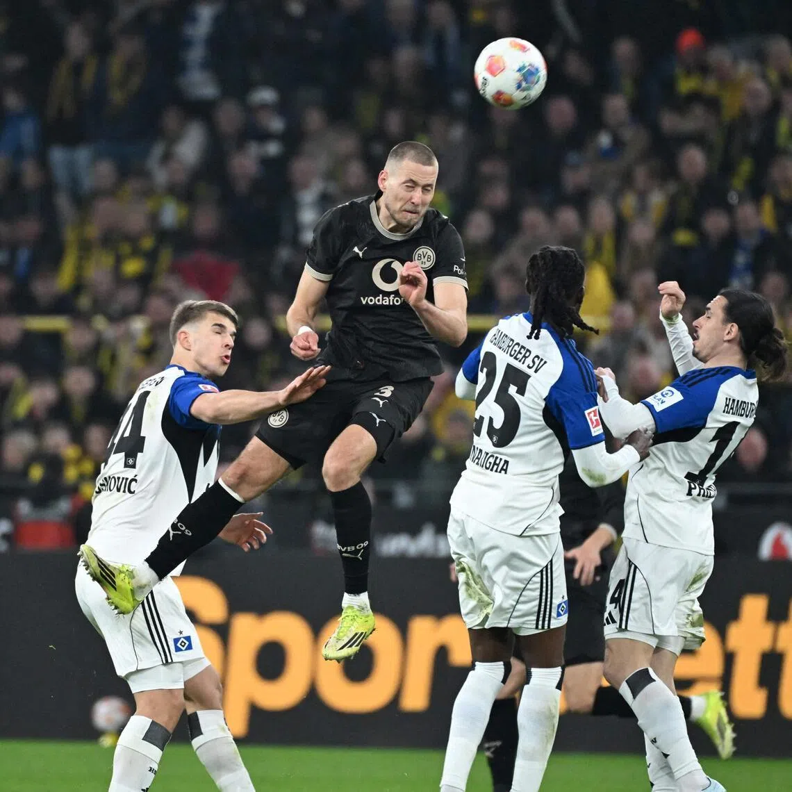 Dortmund's German defender Waldemar Anton heads the ball in the German Bundesliga home game against Hamburg on March 21, 2026.