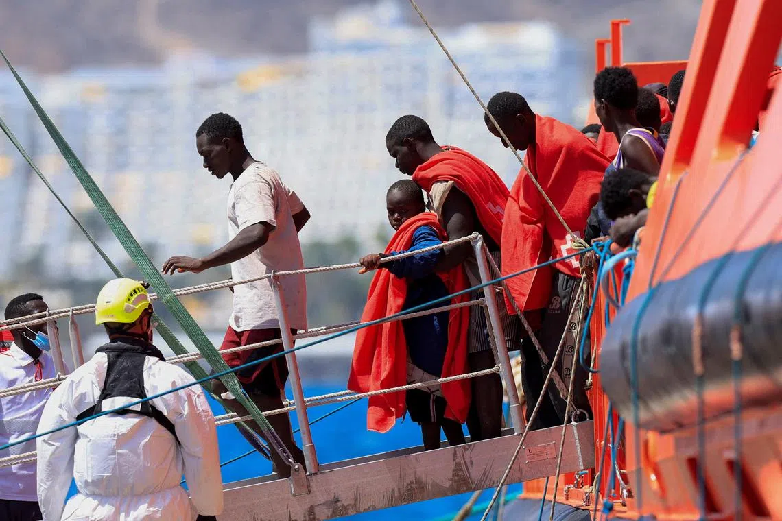 Migrants disembarking from a Spanish coast guard vessel, on the Spanish island of Gran Canaria, in August 2024.