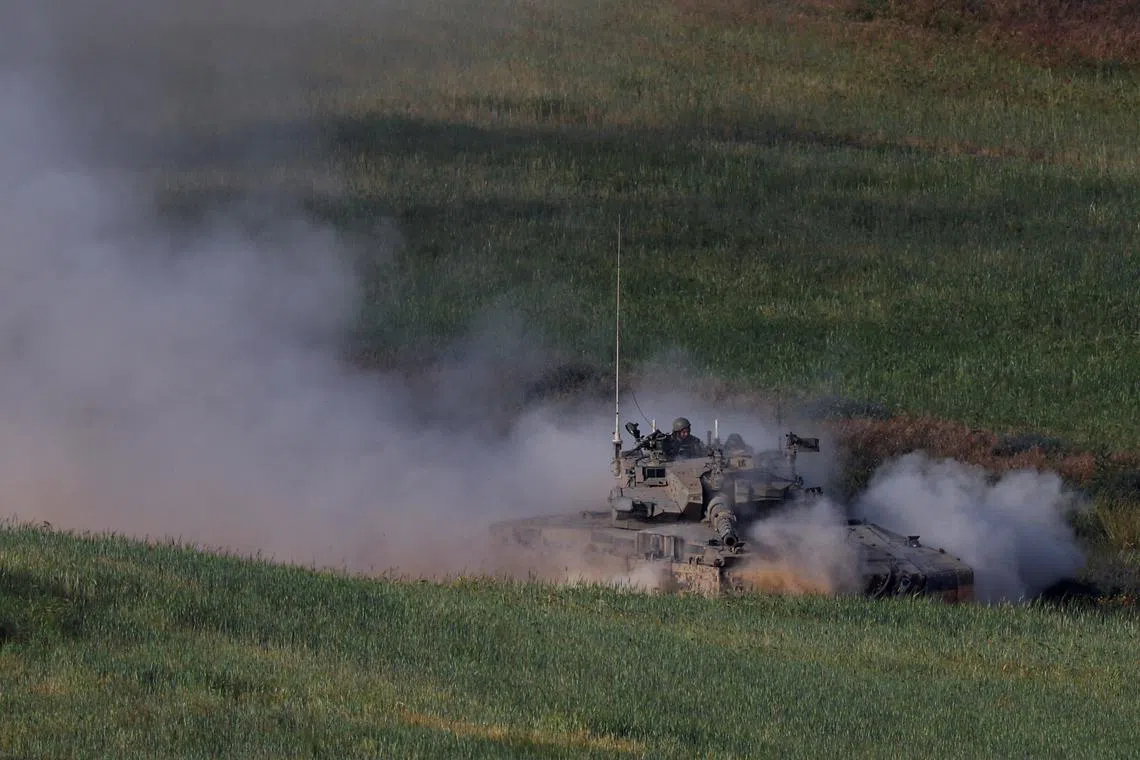 FILE PHOTO: An Israeli tank manoeuvres near the Israel-Gaza border, amid the ongoing conflict between Israel and the Palestinian Islamist group Hamas, in southern Israel, April 2, 2024. REUTERS/Hannah McKay