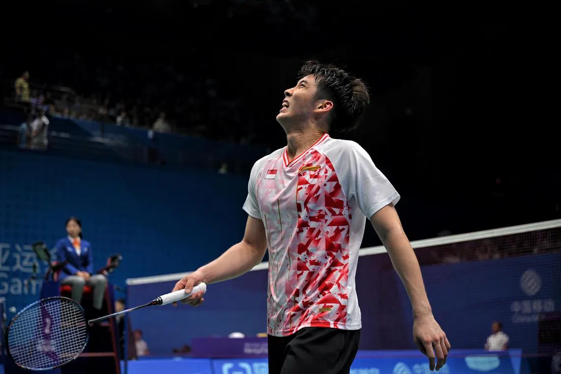Loh Kean Yew of Singapore grimaces after losing to Kenta Nishimoto of Japan during the 19th Asian Games Badminton Men’s Team Round of 16 held at the Binjiang Gymnasium on Sept 28, 2023.