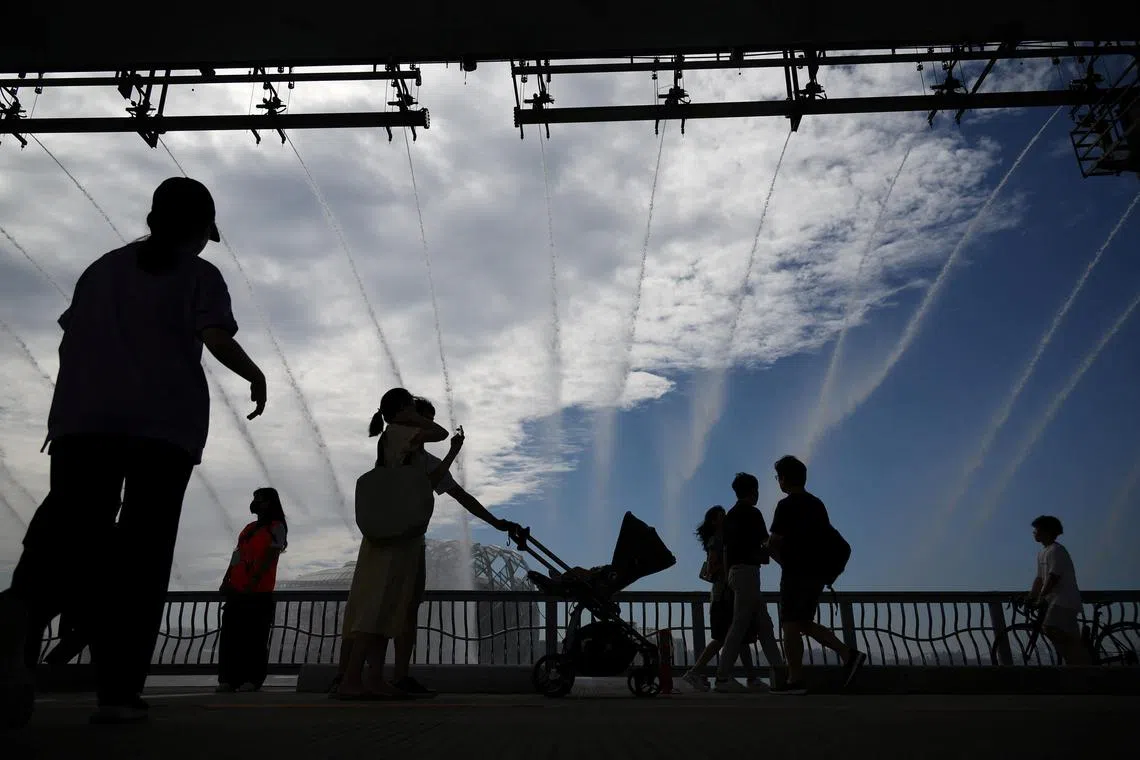 People walk on a Han river bridge on an early autumn day in Seoul, South Korea, September 18, 2022.   
