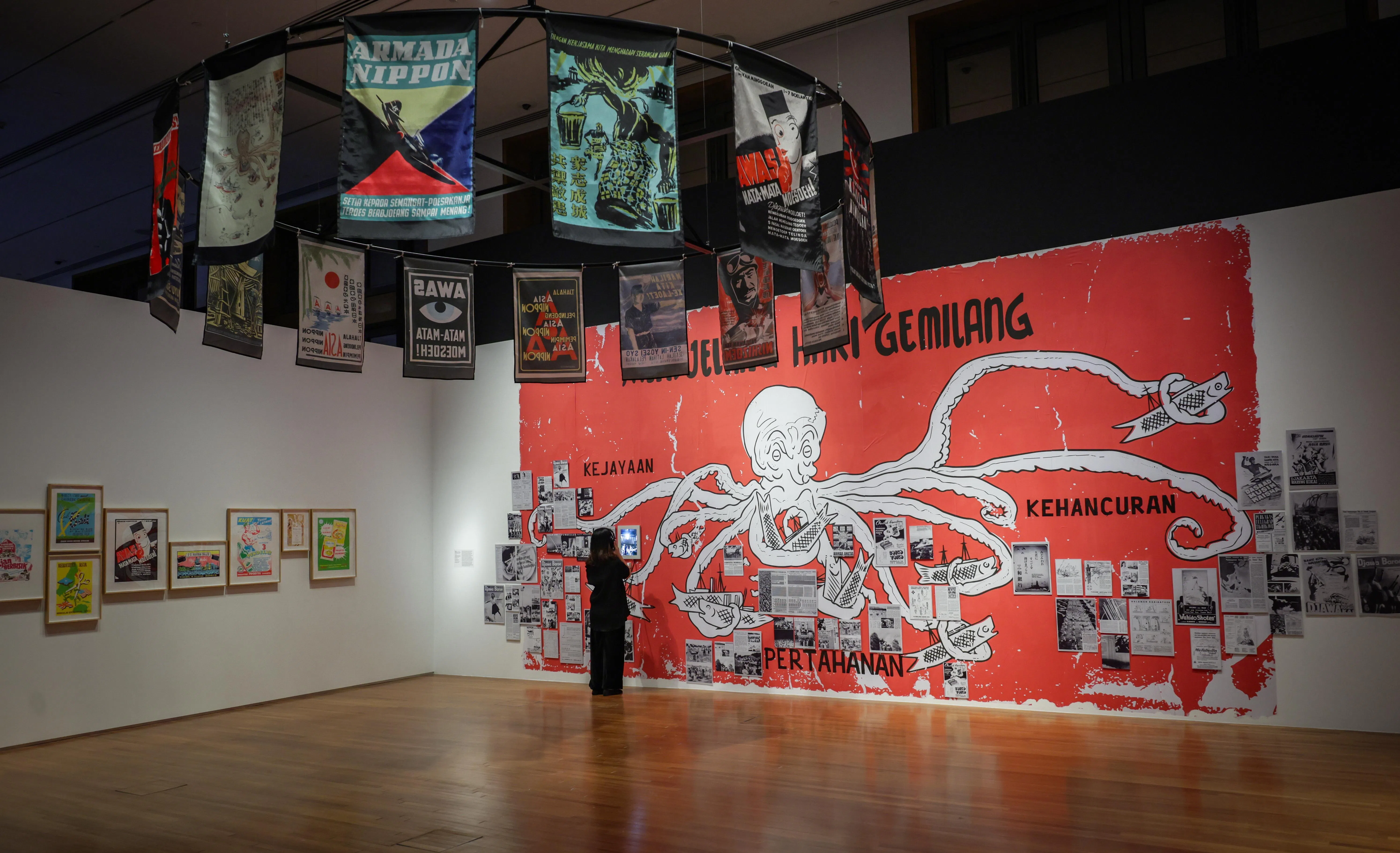 Yogyakarta-based printmaking collective Krack! has assembled a colourful archive of colonial propaganda across banners, videos, print materials and a mural.
