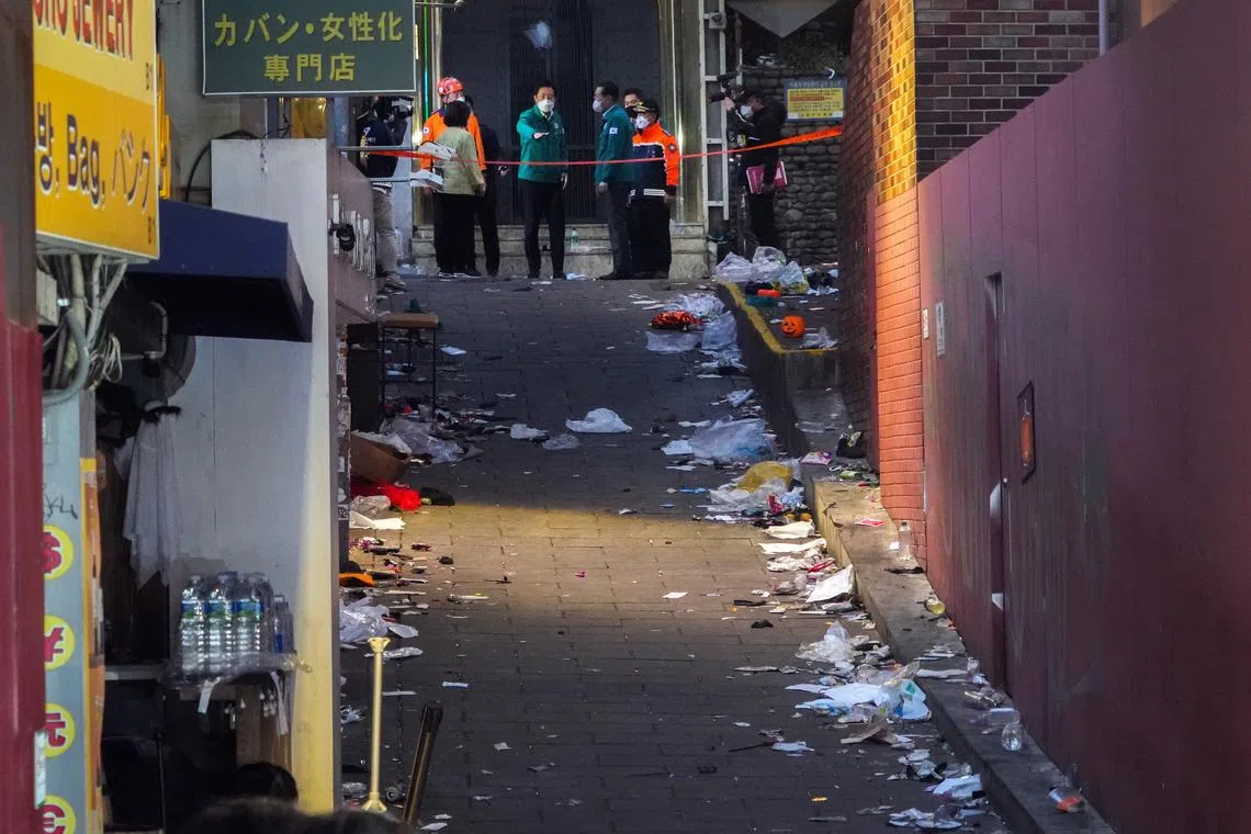 Officials on Sunday, October 30, 2022, at the alleyway where most of the deaths occurred in the crowd surge the day before. 