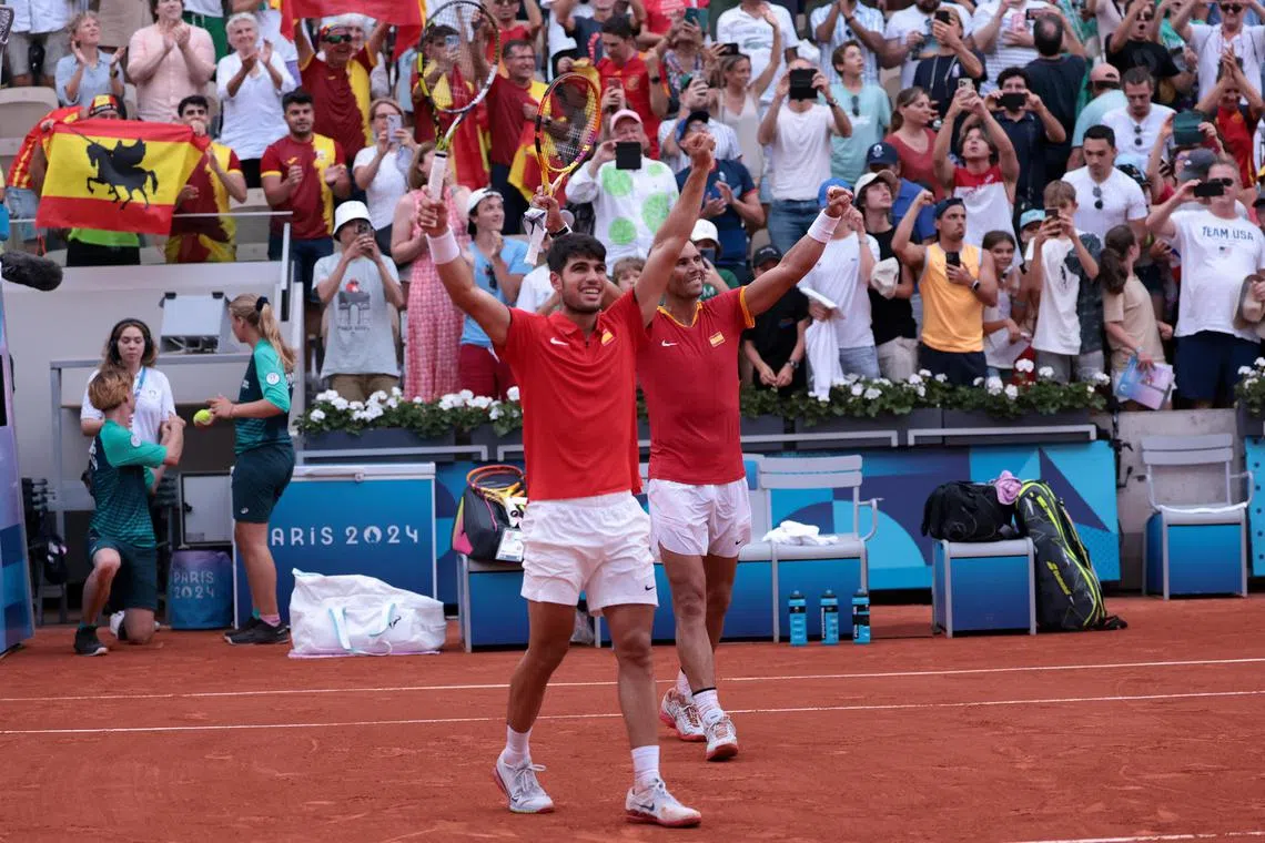 Spain's Carlos Alcaraz (left) and Rafael Nadal celebrate after winning their match against the Netherlands' Tallon Griekspoor and Wesley Koolhof.