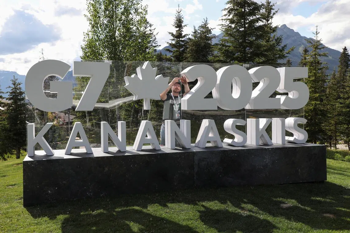 A worker prepares a sign ahead of the G7 summit at a satellite location in Banff, Alberta, Canada, June 14, 2025. REUTERS/Amber Bracken