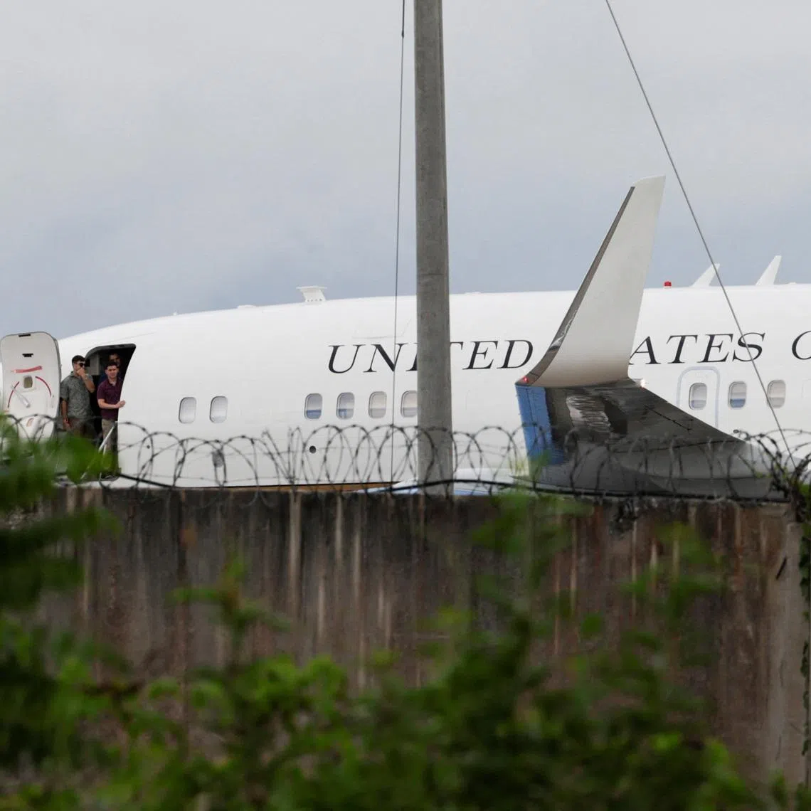 People stand at the gate of a U.S. government plane on the tarmac before departure at Jose Marti International Airport in Havana, Cuba, May 14, 2026. REUTERS/Norlys Perez