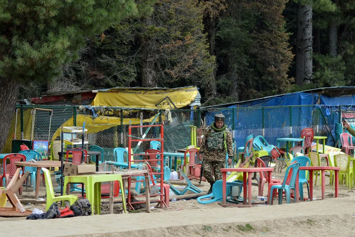 An Indian security force personnel walks amid toppled chairs and tables at the site of a suspected militant attack on tourists in Baisaran near Pahalgam in south Kashmir's Anantnag district, April 23, 2025. REUTERS/Stringer/File Photo