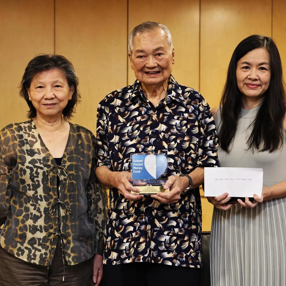 ST School Pocket Money Fund general manager Tay Hwee Leng (far right) receiving a $500,000 cheque from the executors of Victor Lee’s will.